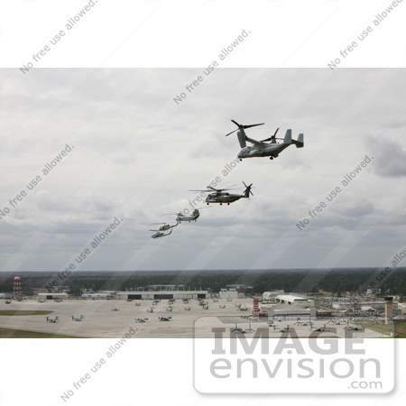 #35242 Stock Photo of a V-22 Osprey, CH-53E Super Stallion Helicopter, CH-46 Sea Knight Helicopter, UH-1N Huey Aircraft, And an AH-1 Cobra Aircraft Performing a Formation Flight by JVPD