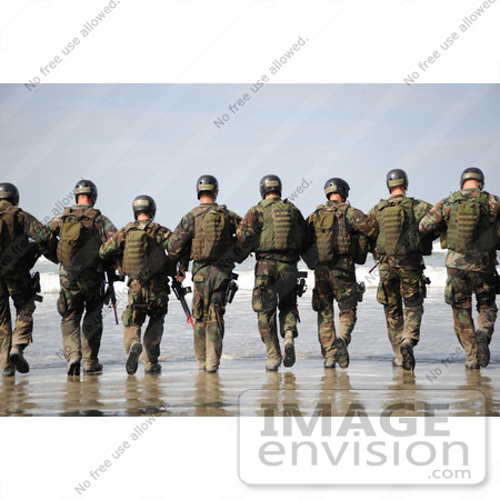 #36182 Stock Photo Of A Line Of Soldiers Walking Away Towards The Surf On A Beach by JVPD