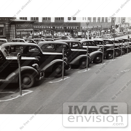 #37681 Stock Photo Of Vintage Cars Lined Up In Parking Spots With Parking Meters On The Sidewalk In Omaha, Nebraska, 1938 by JVPD