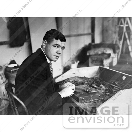 #41225 Stock Photo of Babe Ruth Seated At A Table And Rolling Cigars by JVPD
