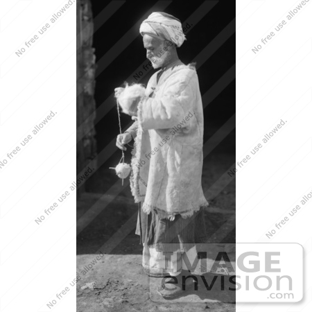 #43459 RF Stock Photo Of A Black And White Ramallah Peasant Man Spinning Wool by JVPD