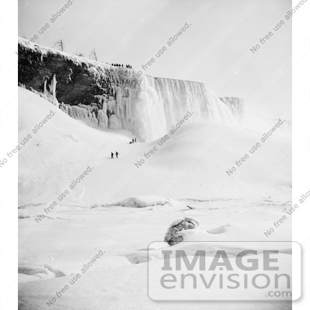 #48821 Royalty-Free Stock Photo Of People Walking Through The Snow Towards An Icy Mountain At Niagara Falls In Winter by JVPD