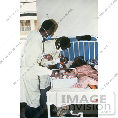 #6294 Picture of a Doctors Giving Health Care to a Female Lassa Fever Patient in the Segbwema, Sierra Leone Clinic by KAPD