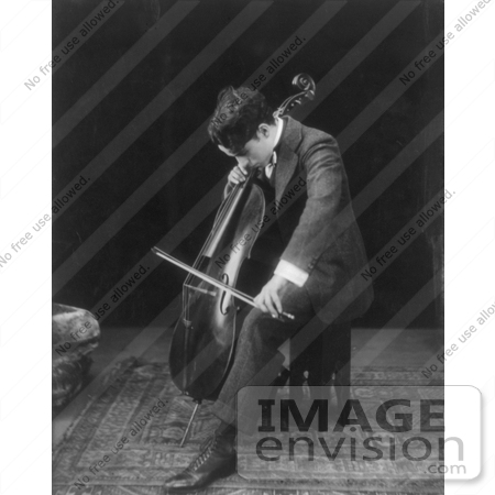 #7350 Black and White Stock Photograph of Charlie Chaplin Seated and Playing a Cello by JVPD