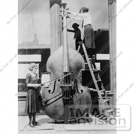 #7373 Stock Image of Women Tuning the Largest Violin by JVPD