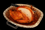 Thanksgiving Cut Turkey with a Knife in a Pan