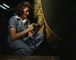 Stock Photo of a Riveter Woman Working on a Consolidated Bomber