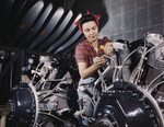Photo of a Riveter Woman Working on Wires of a Motor
