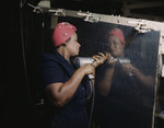 African American Woman Drilling on Side of Bomber