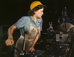 Lathe operator machining parts for transport planes at the Consolidated Aircraft Corporation plant