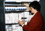 Person Standing In Front of a Drug Repository