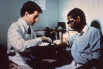 Doctor Examining a Patient in a Local STD Clinic