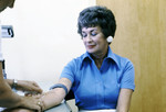 Health Practitioner Obtaining a Blood Sample from a Female Patient