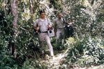 Researchers Transporting Light Trap Equipment During an Arbovirus Field Study