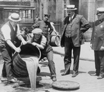 Men Pouring Liquor Into a Sewer During Prohibition