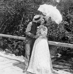 Man and Woman Kissing Under a Parasol