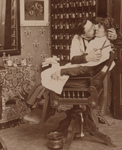Man Kissing a Woman While Cutting Her Hair