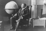 Theodore Roosevelt Sitting by Globe