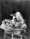 Ethel Barrymore Putting a Baby in a Crib