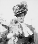 Woman Holding a Pekinese Dog