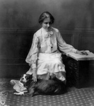 Helen Keller Reading Braille and Petting a Dog