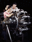 Picture of a Man and Woman Working on an Airplane Engine