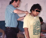 Industrial Hygienist Preparing to Take an Air Sample from a Worker Who Was Exposed to Harmful Substances Found in a Fireworks Manufacturing Shop in Tultepec, Mexico