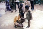 Nigerian Children Being Weighed On a Scale