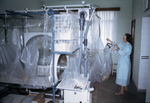 South African Virologist Adjusting Plastic Ebola Virus Isolators
