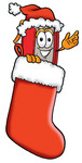 Clip Art Graphic of a Book Cartoon Character Wearing a Santa Hat Inside a Red Christmas Stocking