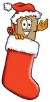 Clip Art Graphic of a Cardboard Shipping Box Cartoon Character Wearing a Santa Hat Inside a Red Christmas Stocking