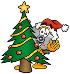 Clip Art Graphic of a Flash Camera Cartoon Character Waving and Standing by a Decorated Christmas Tree