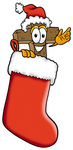 Clip Art Graphic of a Wooden Cross Cartoon Character Wearing a Santa Hat Inside a Red Christmas Stocking