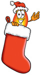 Clip Art Graphic of a Fire Cartoon Character Wearing a Santa Hat Inside a Red Christmas Stocking