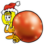 Clip Art Graphic of a Yellow Electric Lightbulb Cartoon Character Wearing a Santa Hat, Standing With a Christmas Bauble