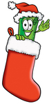 Clip Art Graphic of a Rolled Greenback Dollar Bill Banknote Cartoon Character Wearing a Santa Hat Inside a Red Christmas Stocking