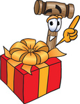 Clip Art Graphic of a Wooden Mallet Cartoon Character Standing by a Christmas Present
