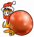 Clip Art Graphic of a Red Paintbrush With Yellow Paint Cartoon Character Wearing a Santa Hat, Standing With a Christmas Bauble
