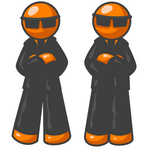 Clip Art Graphic of Two Orange Guy Characters In Black Suits And Shades, Standing Still With Their Arms Crossed