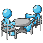 Clip Art Graphic of a Sky Blue Guy Character Chatting With a Friend at a Table